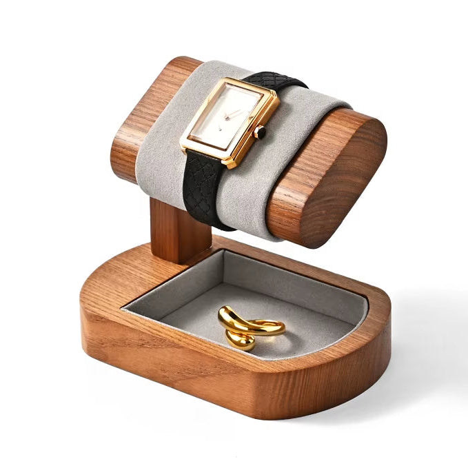 Wooden jewelry display stand with a watch and ring on a white background