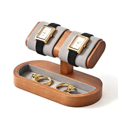 Wooden jewelry display stand with watches and rings on a white background